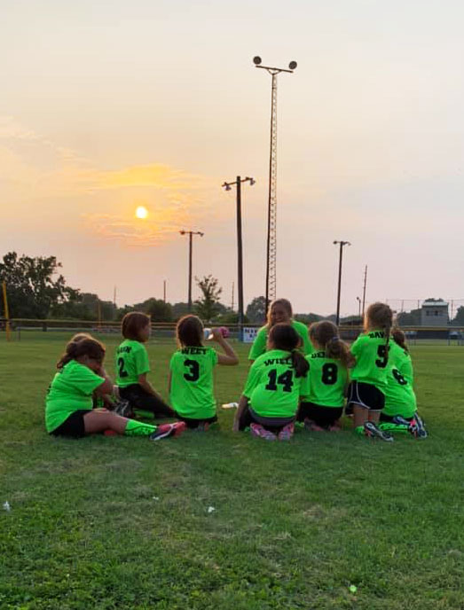 Petersburg Little League team with setting sun